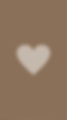 a white heart on a brown background with the shadow of a person's head