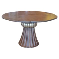 a round wooden table with metal pedestals on it's sides and an oval wood top