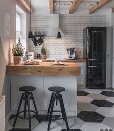 two stools are in front of the kitchen counter