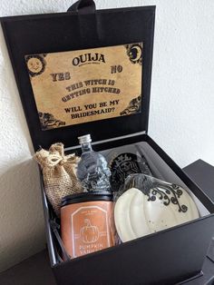 an open black box containing soaps and candles