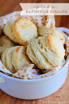 buttermilk biscuits in a white bowl on a wooden table