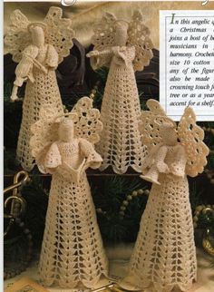 three crocheted angel figurines are shown in front of a christmas tree