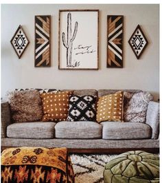 a living room filled with lots of furniture and pillows on top of a rug covered floor