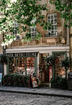 a store front with lots of plants in the window