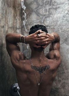 a man with his hands on his head in the shower