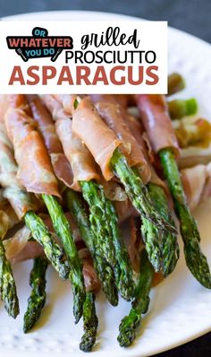 asparagus and prosciutto wrapped in bacon on a white plate