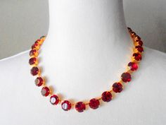 "Georgian ruby red statement choker Necklace with Austrian Crystals. * Crystal Color: Ruby Red * Length: 16.5\" + 1.5\" Rolo Extender chain. * Metal Color: 14K Gold Plated * Nickel-free and Lead-Free * * Helpful tips for proper care: To avoid damaging or dulling Costume Jewelry, do not use jewelry cleaner or soak the jewelry in water. When dressing, I would recommend that you put jewelry on last in order to avoid the damaging effects of hair spray and/or perfume. * All costume jewelry needs spec Round Ruby Necklace For Party, Red Ruby Choker Necklace, Red Single Strand Jewelry For Party, Red Choker Necklaces For Formal Occasions, Red Choker Necklace For Formal Occasions, Formal Red Choker Necklaces, Formal Red Choker Necklace, Red Single Strand Jewelry For Formal Occasions, Formal Red Single Strand Jewelry