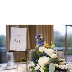 a table setting with flowers and place cards