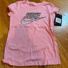 Nike Pink Short Sleeve Tee Nwt Size 6x Fitted Short Sleeve T-shirt For Playwear, Spring Sports Cotton Shirt, Cute Pink Sports Tops, Basic Tops For Playwear In Spring, Basic Spring Playwear Tops, Basic Spring Tops For Playwear, Cute Cotton Sports Top, Nike Fitted Graphic Print Top, Nike Fitted Top With Graphic Print