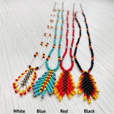 six beaded necklaces with different colors and designs on them, all lined up together