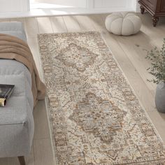 a living room with a couch and rug on the floor