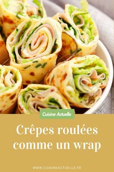 some food that is in a bowl on a table with the words crepes roulees comme un wrap