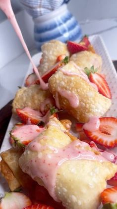 strawberry shortcakes with icing and strawberries on a plate