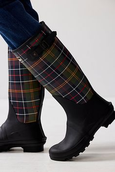 Stay protected from the rain in timeless style with these tartan-adorned rain boots from Barbour. **Features:** Knee-high length, all-rubber uppers, round toe, tartan-adorned shaft, adjustable buckle detail, tread outsole**Why We <3 It:** Perfect for making a chic statement on an inclement day. Wax Jackets, Country Outfits, Boho Clothing, Quilted Jacket, The Rain, Timeless Style, Rain Boots, Black Boots, Knee High