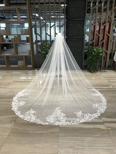 a white wedding veil is on the floor