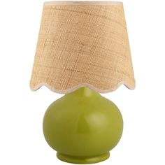 a green table lamp with a beige shade on it's side and a white background