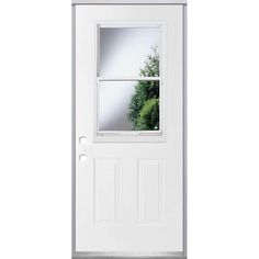 a white door with an open window on the side and green plants in the reflection