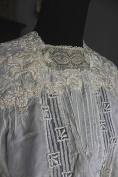 "Outstanding museum quality intricately embroidered antique silk blouse. Off white cream color. Very wearable size that fits up to 36\" bust. 3/4 loose fitting sleeves. Extensive cream color hand embroidery on bodice and sleeves. It is 14\" across waist when laying flat and 17\" long from mid shoulder to hem. Hooks and eyes for closure up the back. Small inset embroidered panel at front neckline in very pale pastel tones. So very beautiful and in fantastic shape. 1\" area along seem at waist tha Wedding Lace Blouse With Chikankari Embroidery, White Victorian Blouse For Wedding, Vintage White Blouse With Intricate Embroidery, Victorian Lace Wedding Blouse, Victorian Lace Work Blouse For Wedding, Victorian Lace Work Tops For Wedding, Victorian Blouse With Lace Collar For Wedding, Victorian Blouse With Lace Trim For Wedding, Victorian Wedding Blouse With Lace Collar