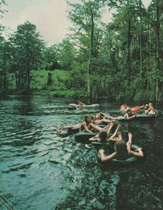 people are floating in the water with sparklers