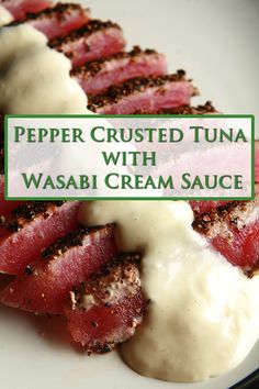 a white plate topped with meat covered in gravy next to a green sign that says pepper crusted tuna with wasabi cream sauce