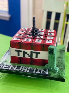 a cake made to look like a minecraft house on top of a green table