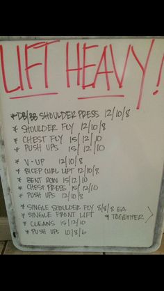 a white sign with writing on it that says lift heavy and the words below it are written in red ink