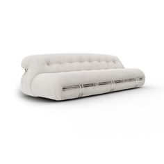 a white couch sitting on top of a white floor