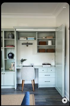 a white desk and some shelves in a room