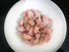 chopped meat in a white bowl on a black table