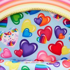 a colorful heart shaped chair with rainbows and hearts on it