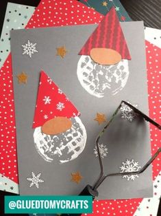 some paper and scissors sitting on top of christmas cards with snowflakes in the background