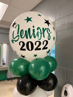 a balloon with the words seniors on it and some black and white balloons in front