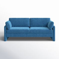 a blue couch sitting on top of a white floor