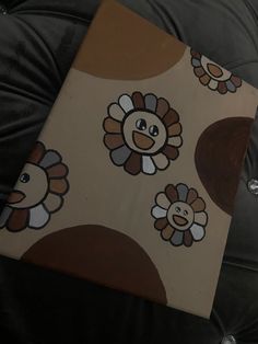 a black leather chair with a brown and white flowered design on the back cover