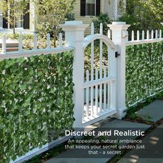 a white picket fence with ivy growing on the top and bottom, in front of a house