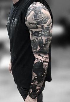 a man with a black and white tattoo on his arm