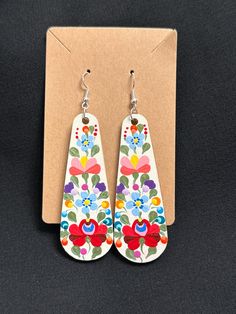 Hand painted Hungarian Matyo Folk Art with acrylic paint and sealed with polyurethane sealer. About 3.5" long and 1.3" wide. Base color is antique white with multicolor design and  metallic green leaves. Comes with Sterling Silver Hook. White Artisan Hand-painted Earrings, White Hand Painted Artisan Earrings, Traditional Hand Painted White Earrings, Traditional White Hand-painted Earrings, Traditional White Hand Painted Earrings, Vintage Hand Painted White Earrings, Vintage White Hand Painted Earrings, Art With Acrylic Paint, Hungarian Folk Art