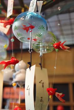 a group of ornaments hanging from the ceiling with numbers on them and birds flying around