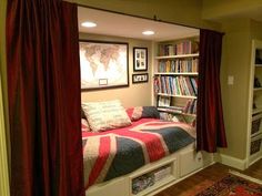 a room with a bed, bookshelf and pictures on the wall