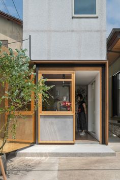 a person standing in the doorway of a house