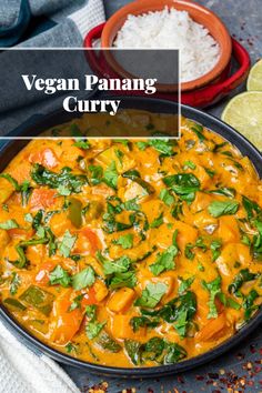 vegan panang curry in a skillet with cilantro and limes