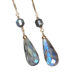 These gorgeous Labradorite faceted stones with their wonderful flashes of aqua and blue are beautifully accented by shimmering Gold components. According to an old Inuit story, a wandering Inuit warrior found the Northern Lights imprisoned in stones along the coast of Labrador. He was able to free most of the lights with a mighty blow of his spear, which are now seen at night in the Northern skies. Some of the lights were still trapped within the stone, and thus we have today the beautiful mineral known as Labradorite. Labradorite has been called a Power stone, perhaps because it is thought to help relieve one's anxiety and depression, and increase one's self-confidence, inner strength, perseverance and energy level. It has been said that Labradorite helps to provide clarity and insight in Faceted Labradorite Dangle Jewelry, Power Stone, The Northern Lights, Inner Strength, Phoenix Az, Energy Level, The Coast, Labradorite, Favorite Jewelry