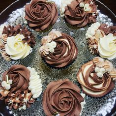 cupcakes with chocolate frosting and flowers on a plate