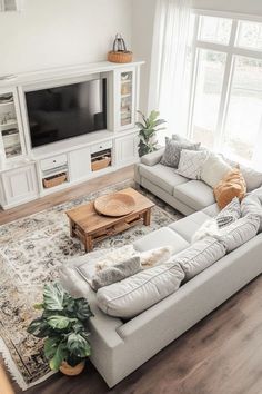 a living room filled with furniture and a flat screen tv on top of a wall