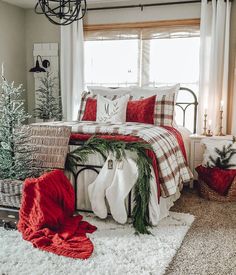 a bedroom decorated for christmas with red and white decor