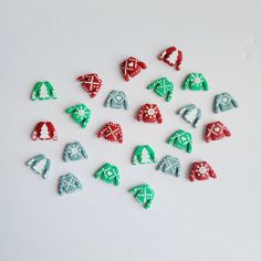 a group of christmas themed buttons sitting on top of a white surface