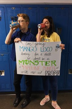 two people standing in front of lockers holding up a sign that says i'm going mango loco