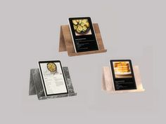 three plaques with different types of food on them