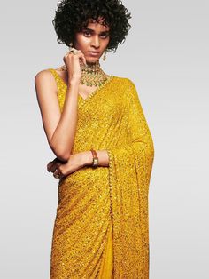 Be an absolute royalty of splendor by adoring this Sabyasachi designer yellow saree in georgette material embellished with all dual sequins work. Accomplished with similar dual sequins choli. The saree surely creates a remarkable look with its sequin motif. This designer surely attract showers of compliment when you will wear it in parties, functions, and weddings. Festive Gold Embellished Pre-draped Saree, Bollywood Style Embellished Festive Pre-draped Saree, Party Wear Embellished Pre-draped Saree For Festivals, Diwali Sequined Pre-draped Saree, Glamorous Sequined Pre-draped Saree For Festivals, Festive Yellow Fitted Pre-draped Saree, Yellow Bollywood Pre-draped Saree, Glamorous Designer Pre-draped Saree For Navratri, Party Wear Pre-draped Sequined Saree For Festivals