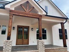 a white house with a wooden front porch